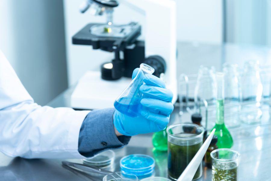 Laboratory research with a microscope and glassware